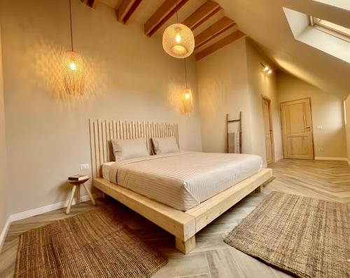 a bedroom with a large bed with a wooden frame at Casa Ido sat Pestera Moieciu in Peştera