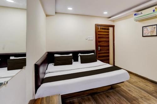 a bedroom with two beds in a room at Hotel O Hotel Krishna's Residency in Indore