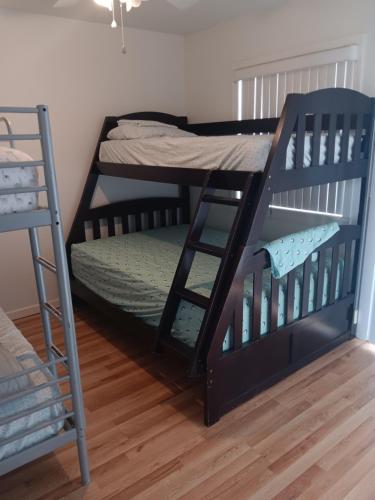 two bunk beds in a room with a ladder at Beautiful Riverview Condo with Boatlaunch in Bullhead City