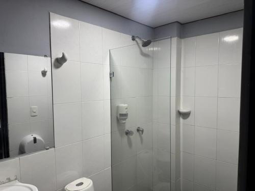 a bathroom with a shower with a glass door at Los Cabos in Bahía Solano