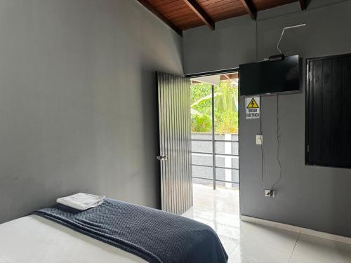 a bedroom with a bed and a television in it at Los Cabos in Bahía Solano
