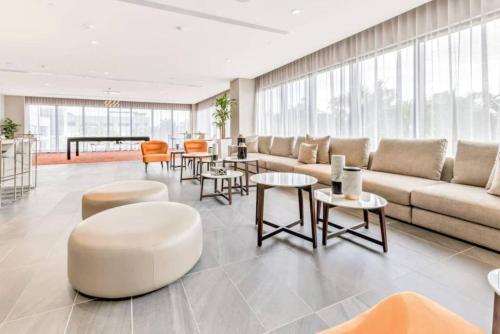 a living room with a couch and tables and chairs at Luxury Condo - 3B3B with Amazing Skyline View in Miami