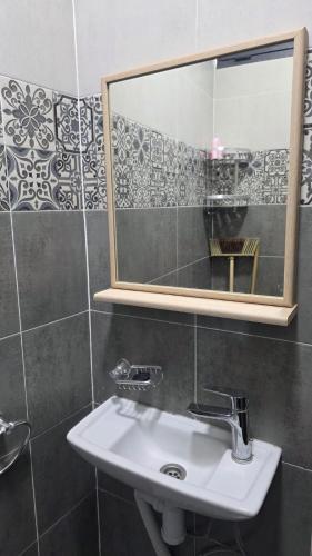 a bathroom with a sink and a mirror at Maison marhaba2 app2 in Inezgane
