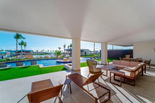 a living room with a patio with a view of a pool at Planet Hollywood Cancun by Royalton, An Autograph Collection All-Inclusive Resort in Cancún