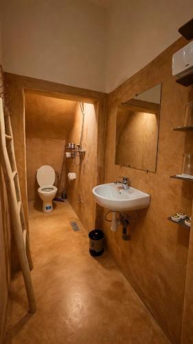 a bathroom with a sink and a toilet at Maison Gourdia in Zouiyya