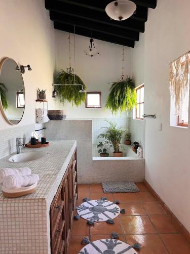 a bathroom with a sink and a mirror at Tierra Alta Boho House in San Miguel de Allende