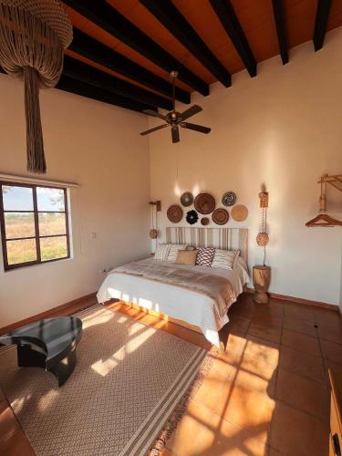 a bedroom with a bed and a ceiling fan at Tierra Alta Boho House in San Miguel de Allende