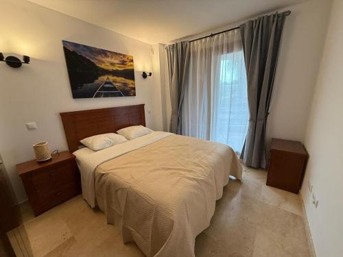 a bedroom with a large bed and a window at Tus vacaciones junto al mar in Torrevieja