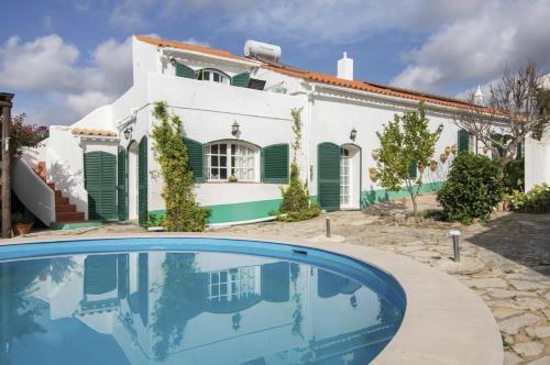 a house with a swimming pool in front of it at Casa Delfim - Casas Azul&Verde in Alte