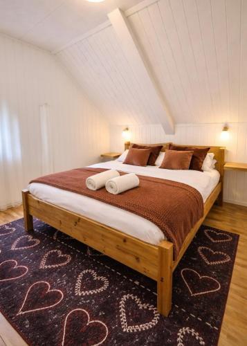 a bedroom with a large bed with two pillows at Dali City Senter Ap 2 in Stavanger