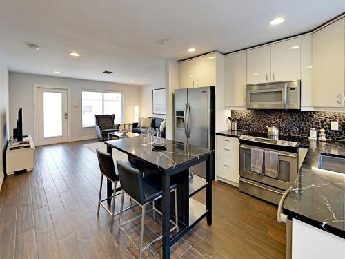 a large kitchen with a table and chairs in it at Hidden Gem Vacation Villa w Private Pool & TikiHut in Fort Lauderdale
