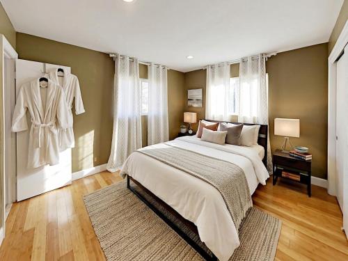 a bedroom with a large white bed and a window at Hidden Gem Vacation Villa w Private Pool & TikiHut in Fort Lauderdale