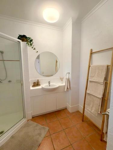 a bathroom with a sink and a mirror at Tropic Sands Coastal Escape in Port Douglas