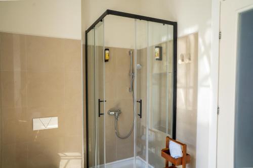 a shower with a glass door in a bathroom at The Wave Seafront Apartment Vis in Vis