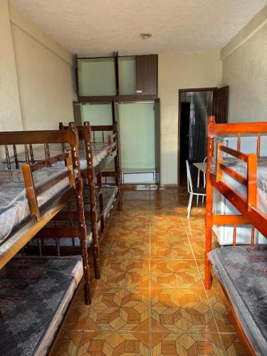 a room with several bunk beds and a table at Pousada Popular in Três Marias