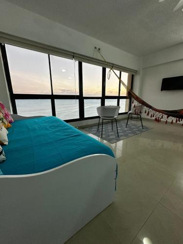 a bedroom with a bed and a view of the ocean at Estudio con Increíble VISTA AL MAR de 1 a 4 huespedes in Porlamar