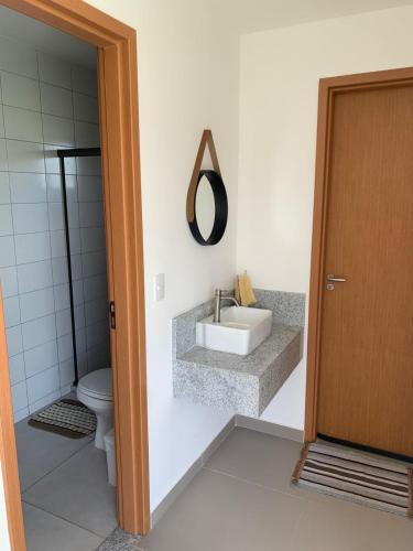 a bathroom with a sink and a toilet at Casa Ville Perignon in Gravatá