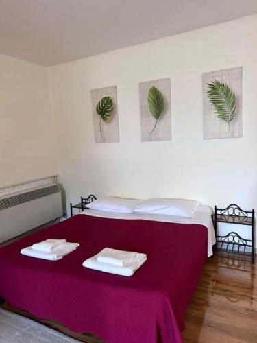 a bedroom with a red bed with towels on it at Al Fluviale in Ferrara