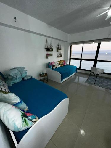 a bedroom with two beds and a view of the ocean at Estudio con Increíble VISTA AL MAR de 1 a 4 huespedes in Porlamar