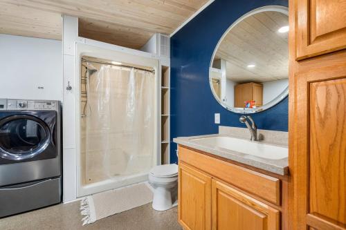 a bathroom with a sink and a washing machine at Mt Rushmore Duplex in Rapid City