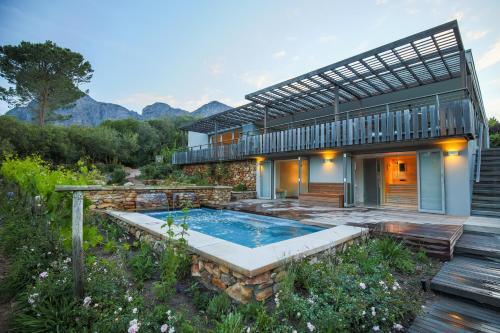 a house with a swimming pool in the yard at Angala in Simondium