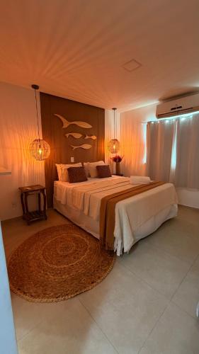 a large bedroom with two beds and a rug at Espaço Move in Porto Seguro