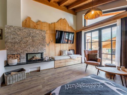 a living room with a fireplace and a couch at Tauernlodge Wagrain Edelweiss 42E in Wagrain