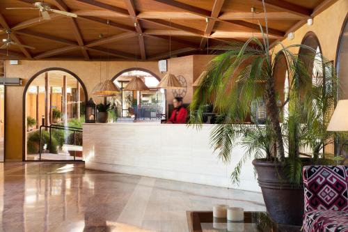 a man standing at the counter of a restaurant at Luna Park Hotel Yoga & Spa in Malgrat de Mar