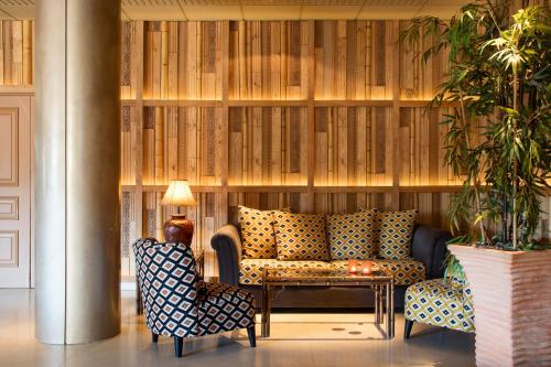 a lobby with a couch and two chairs and a table at Luna Park Hotel Yoga & Spa in Malgrat de Mar