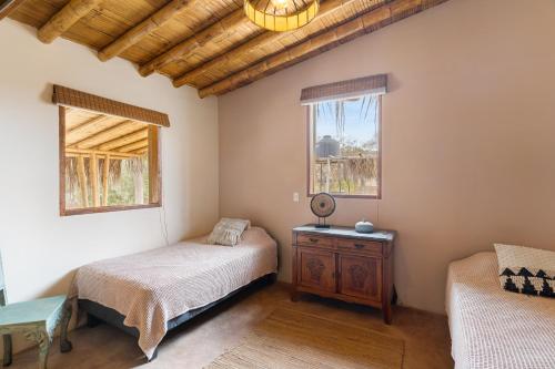 a bedroom with two beds and a window at ALDEA DEL MAR by Villa del Sol in Máncora