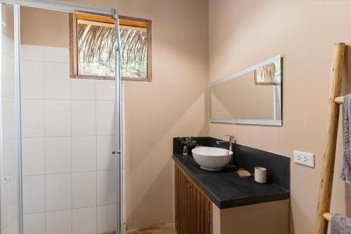 a bathroom with a sink and a shower at ALDEA DEL MAR by Villa del Sol in Máncora