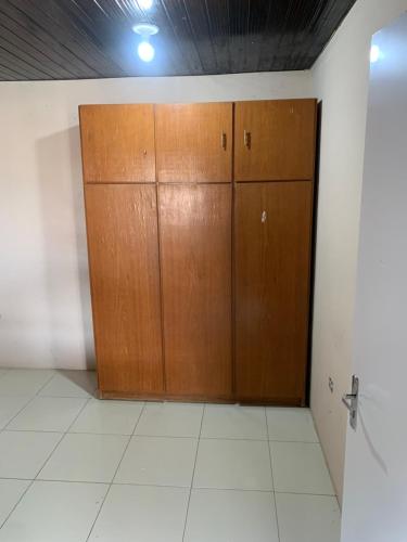 a room with two wooden cabinets and a wall at Espaço Victoria in Caruaru