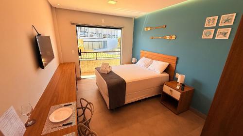 a small bedroom with a bed and a window at Style and lightness 300m from the beach in Salvador