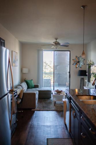 a living room with a couch and a table at Domain Luxe in Austin