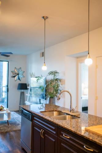 a kitchen with a sink and a counter at Domain Luxe in Austin