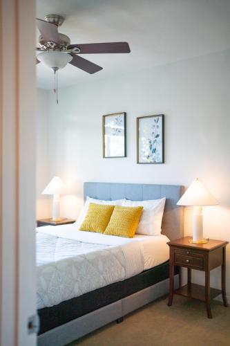a bedroom with a bed with a ceiling fan at Domain Luxe in Austin
