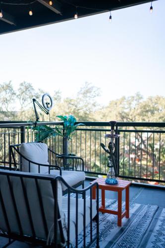 a balcony with chairs and a table on a balcony at Domain Luxe in Austin