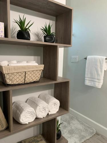 a shelf with towels and plants in a bathroom at Parker Strip Vacation Villa in Parker