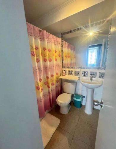 a bathroom with a toilet and a sink at Refugio inca in Cusco