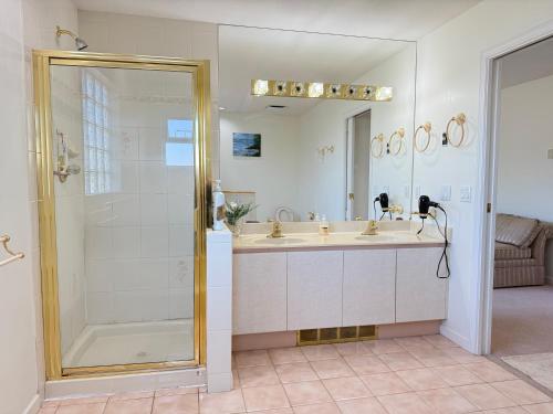 a bathroom with a shower and a sink at As You Wish Suites & Rooms Near YVR with Parking in Richmond