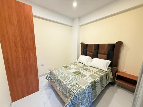 a bedroom with a bed with a quilt on it at Refugio del Viajero in Carhuaz