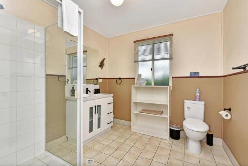 a bathroom with a toilet and a shower at The Meadow Suite in Pokolbin