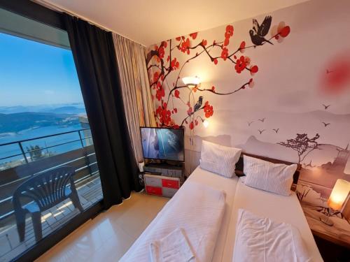 a hotel room with two beds and a television at Studio Rainer mit Pool und Sauna in Freyung