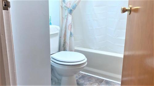 a bathroom with a white toilet and a bath tub at Rulons Cape May Diamond, 2Nd in Cape May