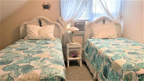 a bedroom with two beds and a window at Rulons Cape May Diamond, 2Nd in Cape May