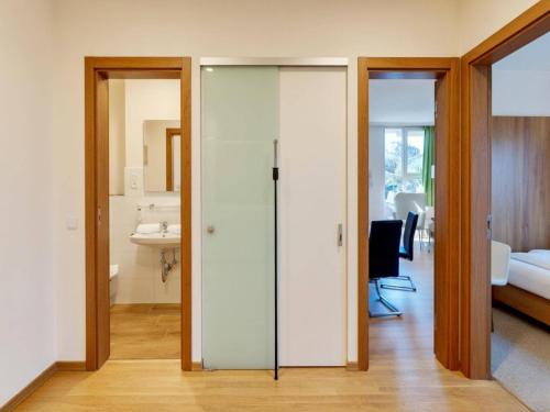 a room with sliding glass doors and a bedroom at Studio Roswitha mit Pool und Sauna in Freyung