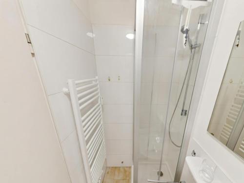 a white bathroom with a shower and a sink at Studio Sebastian mit Pool und Sauna in Freyung