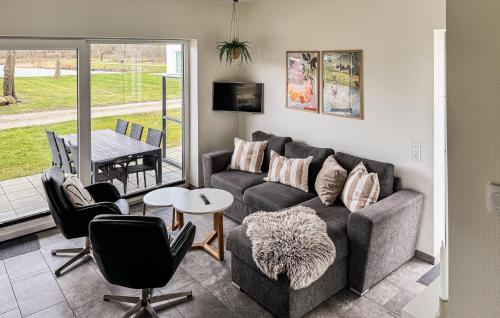 a living room with a couch and chairs and a table at Lovely Home In Ringkøbing With Kitchen in Ringkøbing