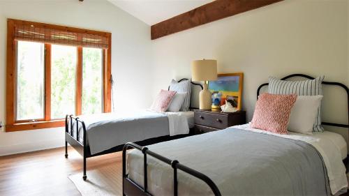 a bedroom with two beds and a window at Songbird Sojourn in Cape May Point