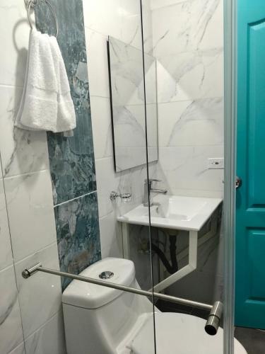 a bathroom with a toilet and a sink and a mirror at Quindio Mio in Filandia